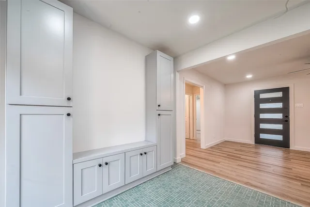 a view of an empty room with wooden floor