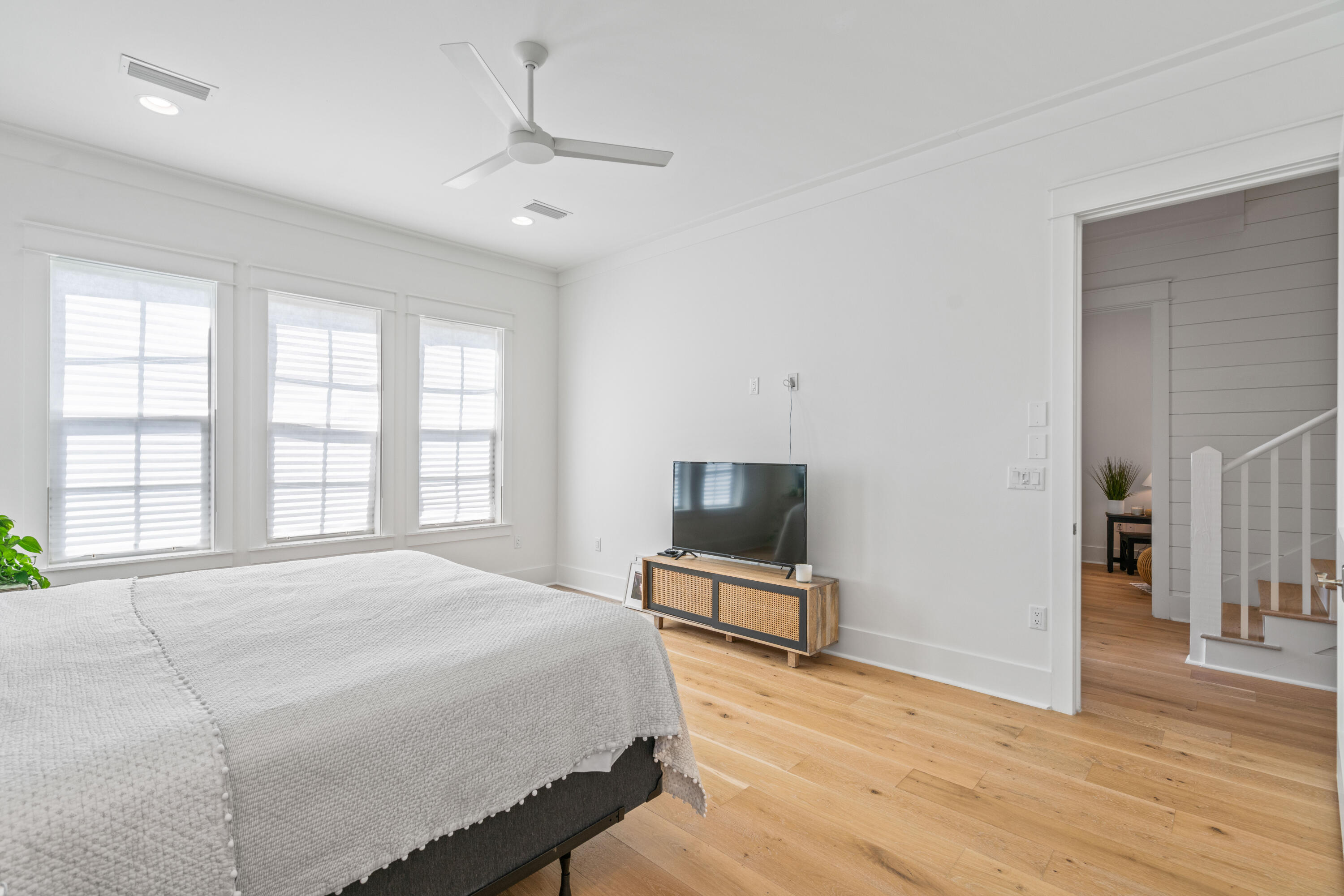 888 Pathways Dr Inlet Beach Inlet Beach, FL 32461 - Photo 24 of 43 a spacious bedroom with a bed and wooden floor
