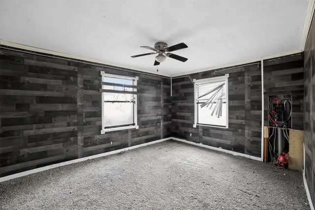 a view of a livingroom with a ceiling fan and window