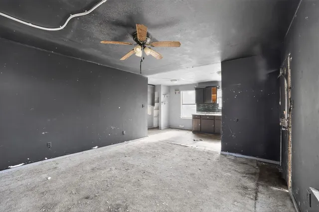 a view of a kitchen with a sink and a chandelier fan