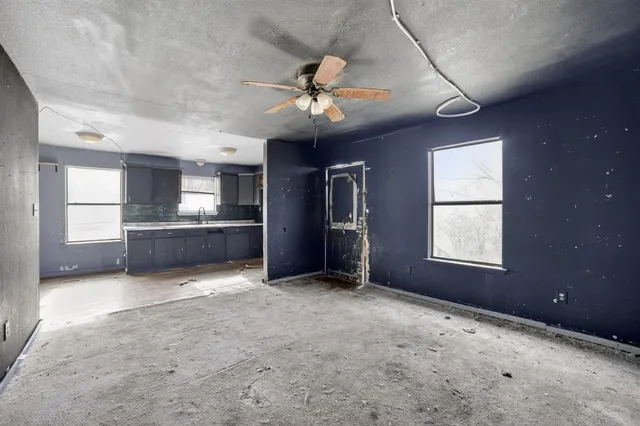 a view of a livingroom with a ceiling fan and window