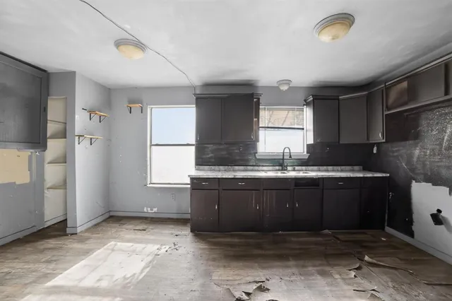 a kitchen with granite countertop a sink and a stove