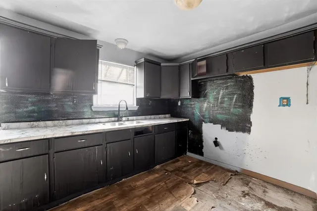 a kitchen with a sink and cabinets