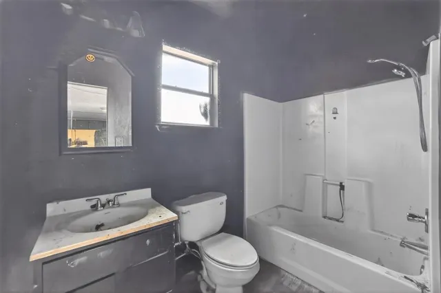 a white toilet sitting next to a bath tub shower