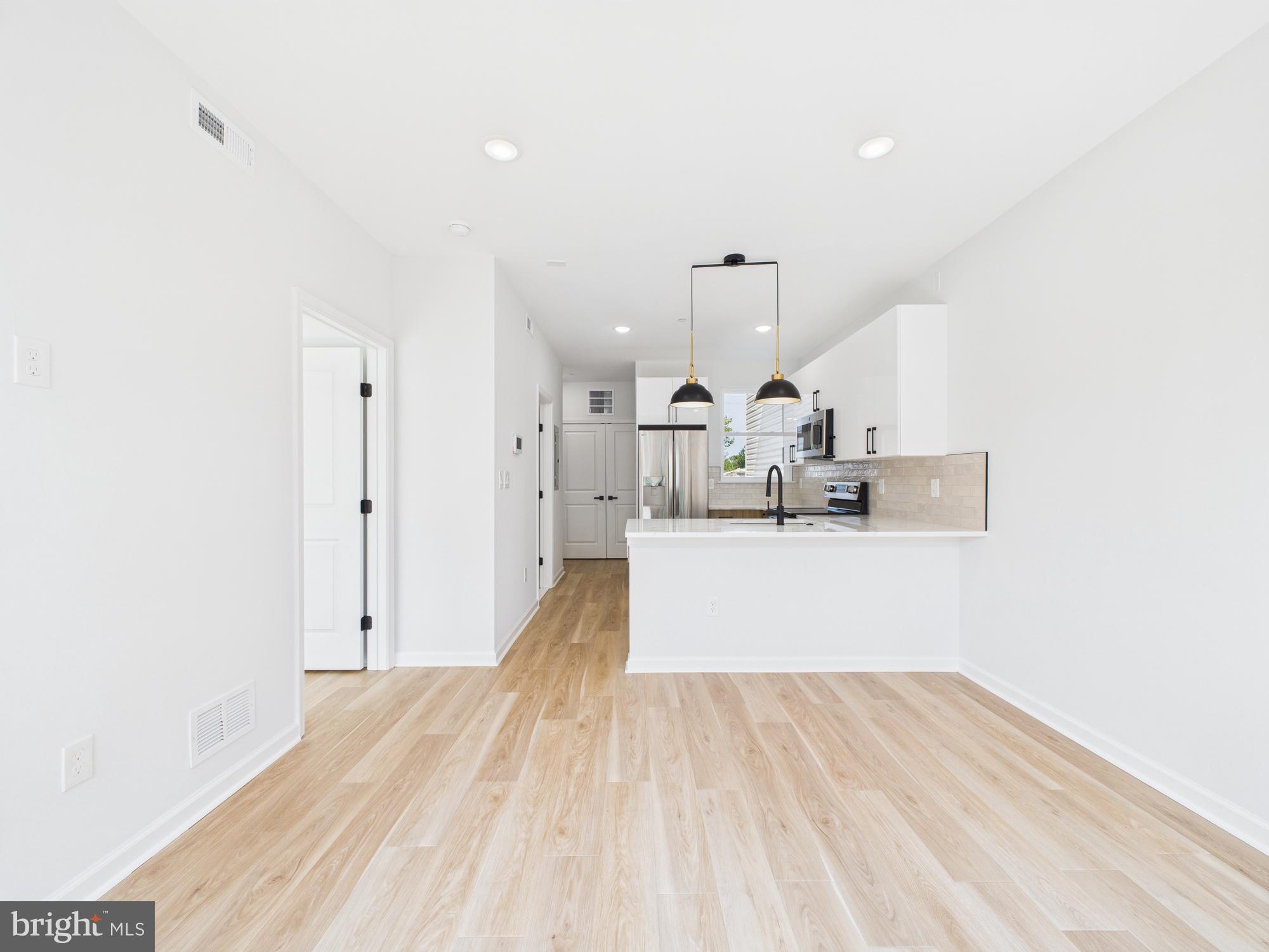 1326 Grove Street, Unit 4 Philadelphia, PA 19146 - Photo 3 of 14 a view of a living room with wooden floor