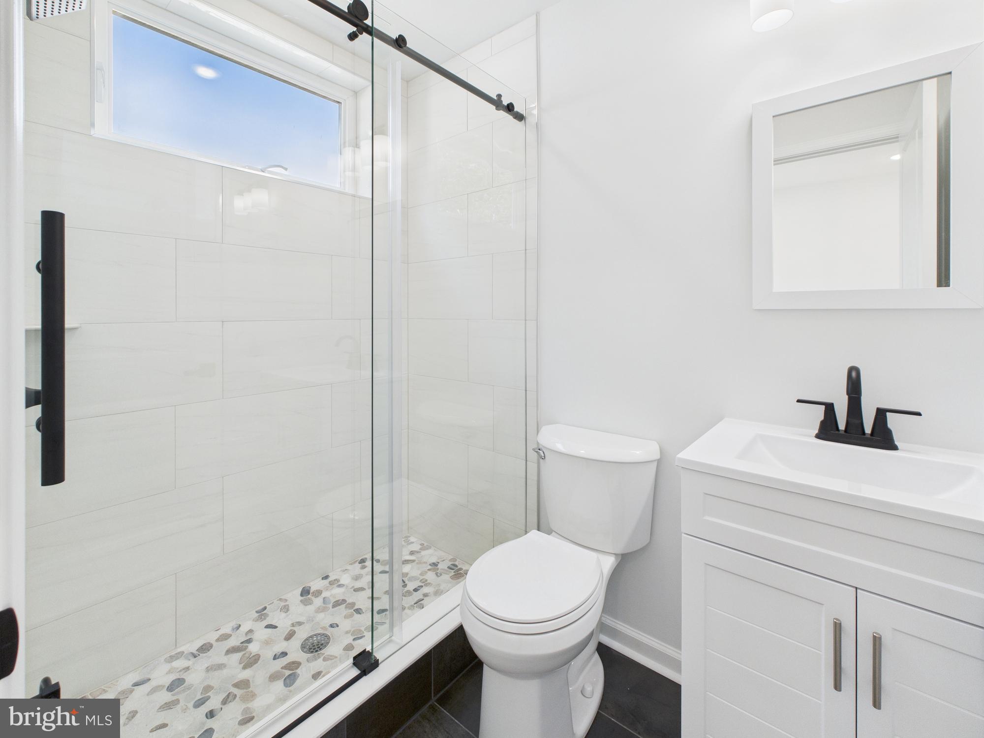1326 Grove Street, Unit 4 Philadelphia, PA 19146 - Photo 4 of 14 a bathroom with a sink a toilet and shower