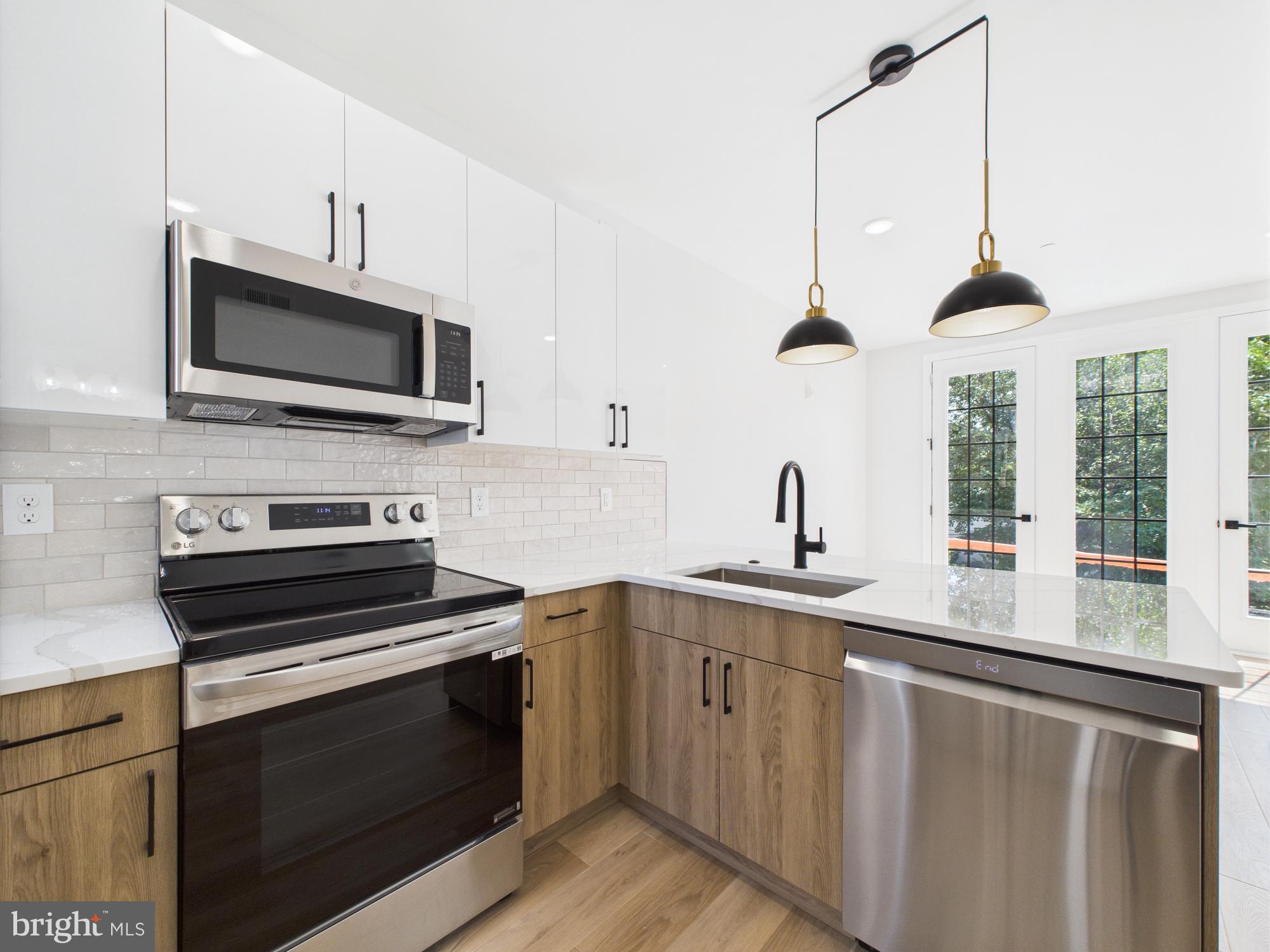 1326 Grove Street, Unit 4 Philadelphia, PA 19146 - Photo 6 of 14 a kitchen with a sink stove and microwave