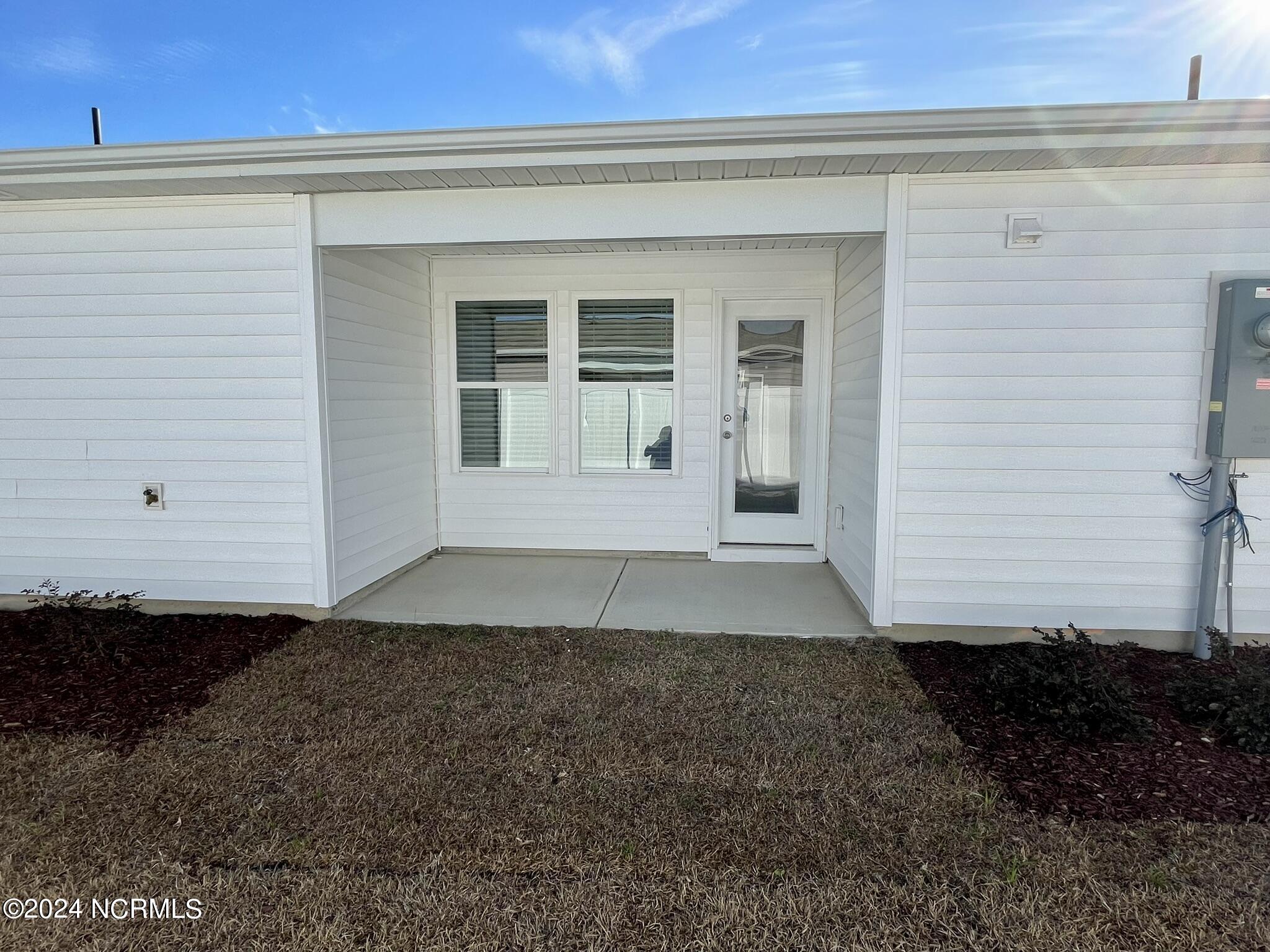 1025 Course Lane Holly Ridge, NC 28445 - Photo 17 of 19 Side Yard with Covered Porch