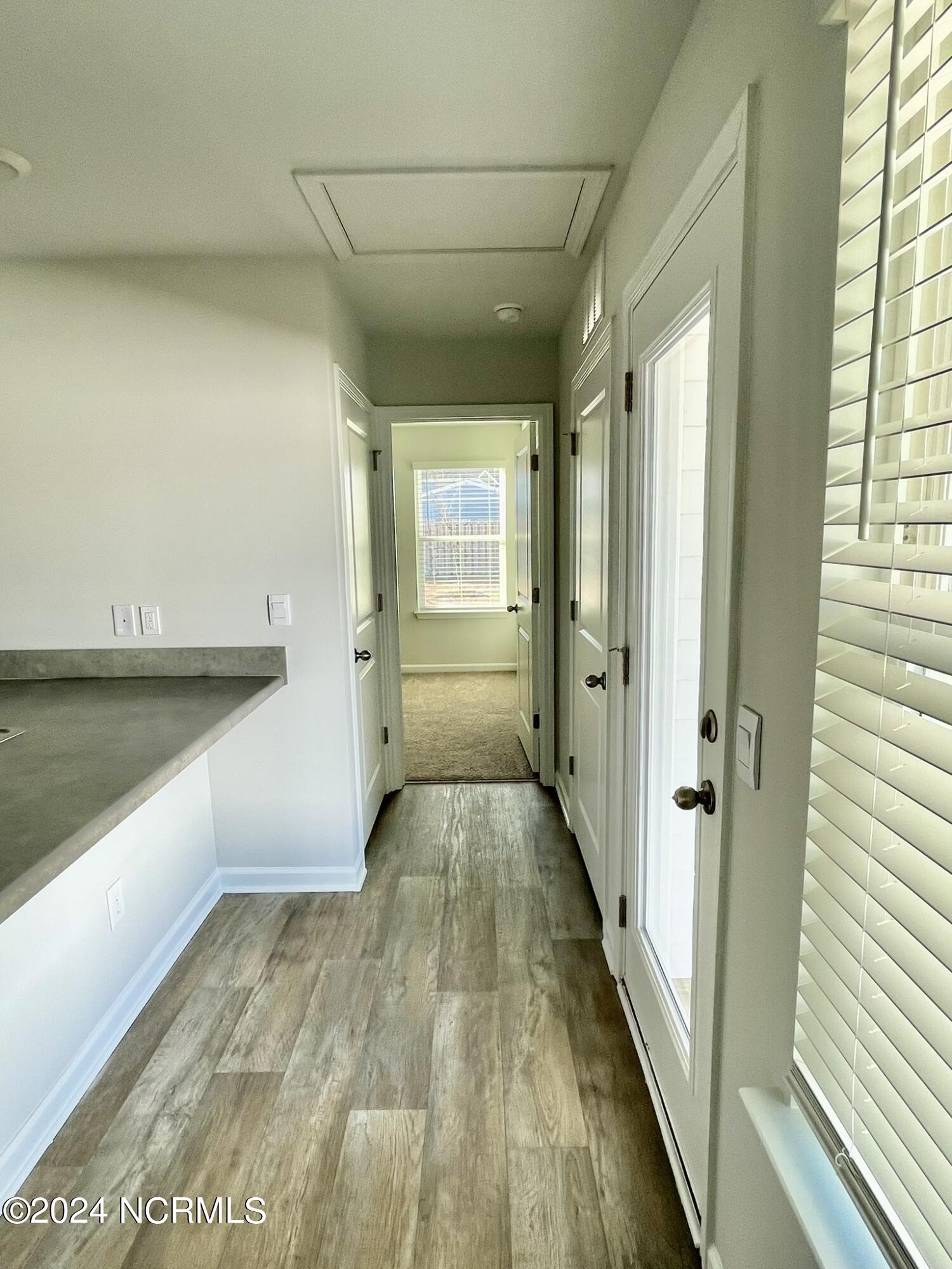 1025 Course Lane Holly Ridge, NC 28445 - Photo 7 of 19 Hallway to Primary Suite
