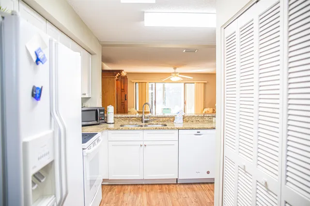 a kitchen with granite countertop cabinets and window