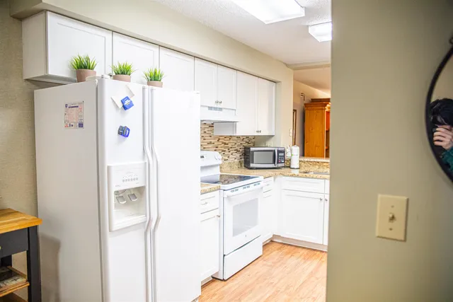 a white refrigerator freezer sitting inside of a kitchen