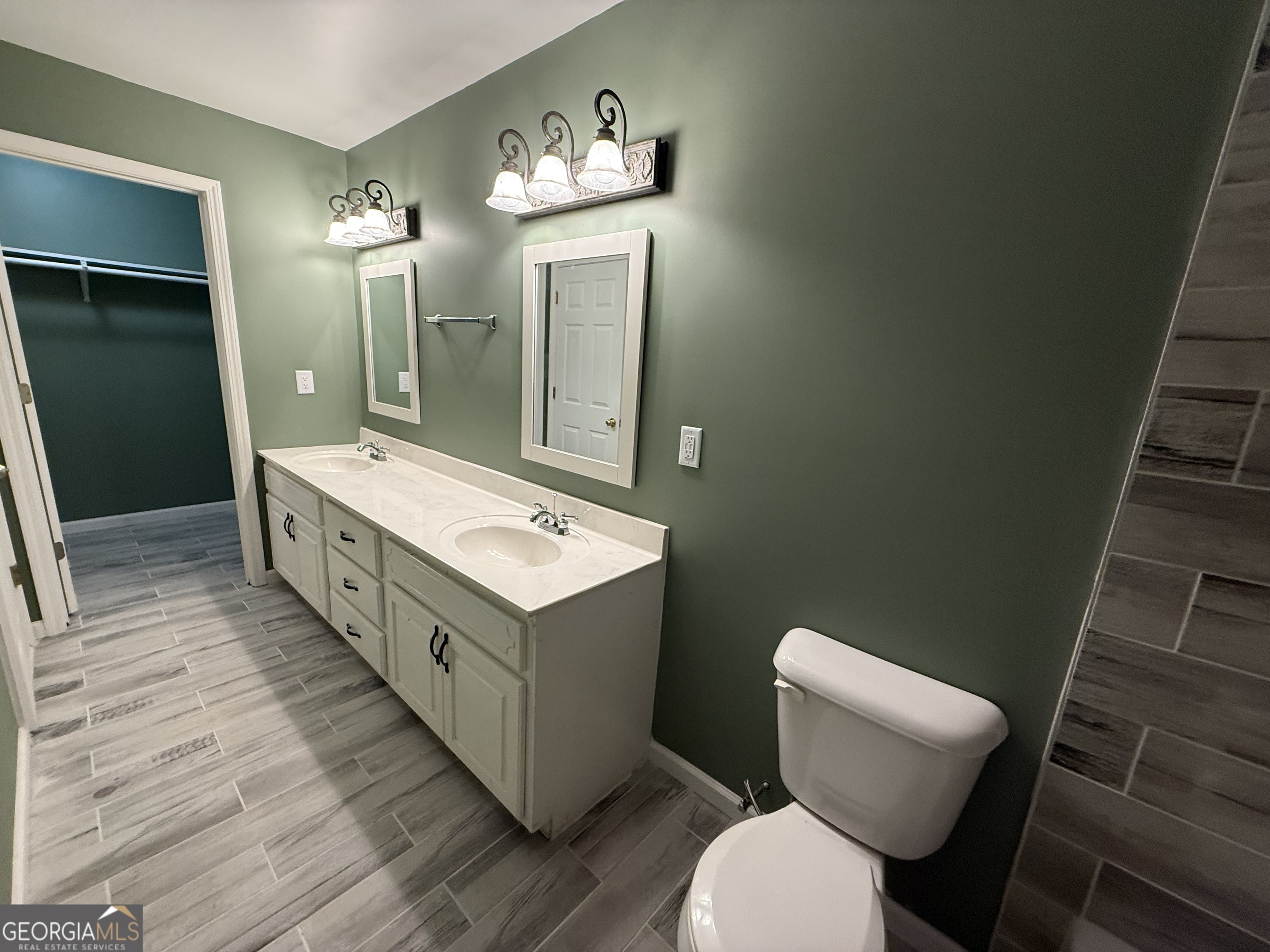 240 Sims Street Barnesville, GA 30204 - Photo 11 of 25 a bathroom with a double vanity sink mirror and toilet