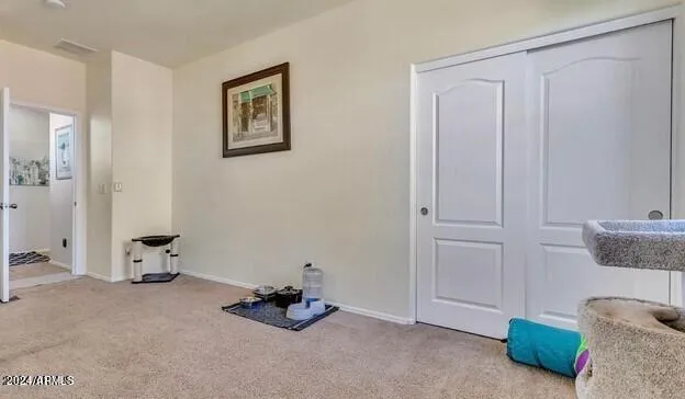 a bedroom with a bed and a painting on the wall