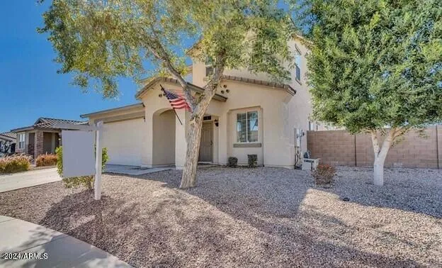 a tree in front of white house