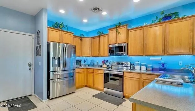 a kitchen with stainless steel appliances granite countertop a refrigerator and a stove