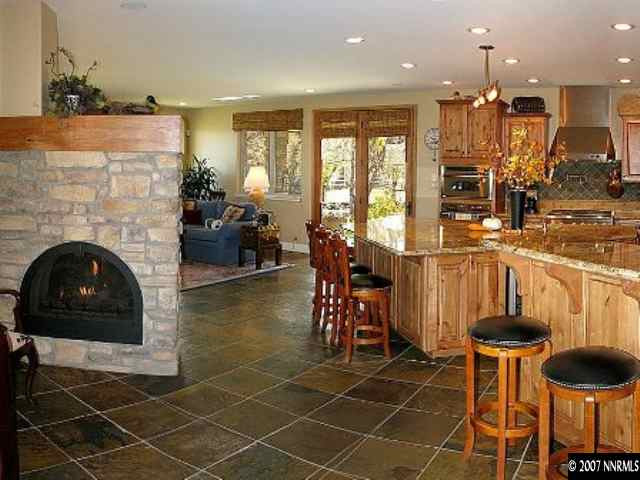 490 Genovese Lane Reno, NV 89511 - Photo 3 of 9 a living room with furniture a dining table and a fireplace