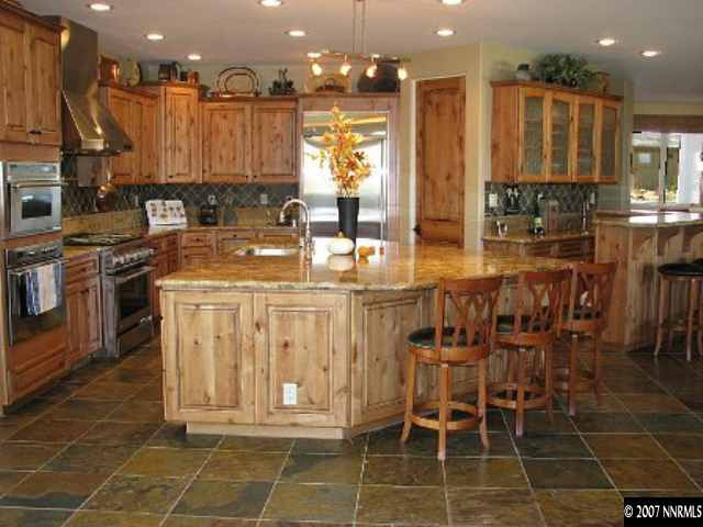 490 Genovese Lane Reno, NV 89511 - Photo 4 of 9 a dining table with a kitchen island granite countertop a table and chairs