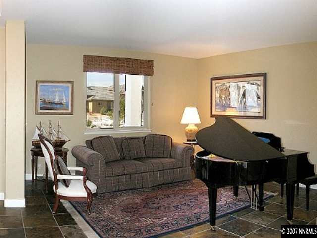 490 Genovese Lane Reno, NV 89511 - Photo 6 of 9 a living room with furniture a piano and a window