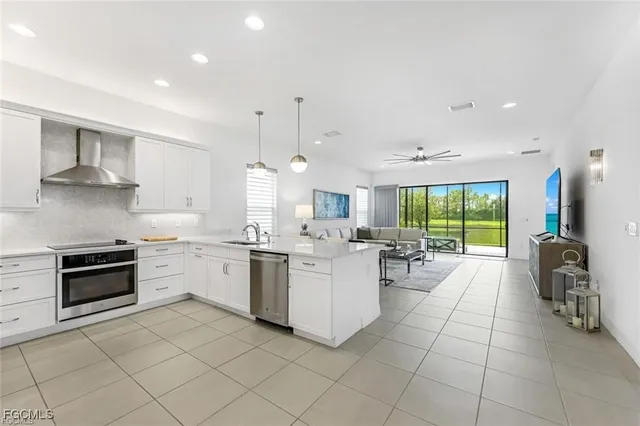 a large kitchen with lots of counter top space and stainless steel appliances