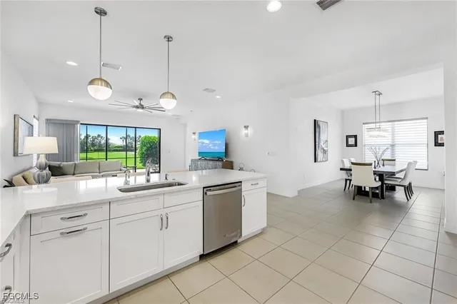 a kitchen with a sink dining table and chairs