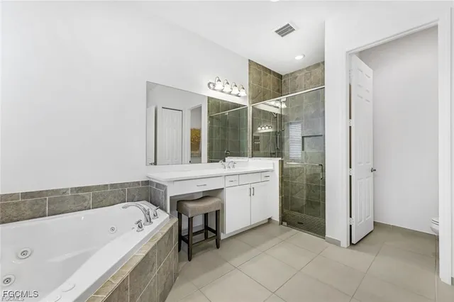 a bathroom with a bathtub a mirror a sink and a shower