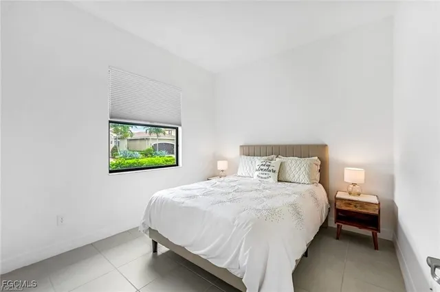 a bedroom with a bed and a wall painting