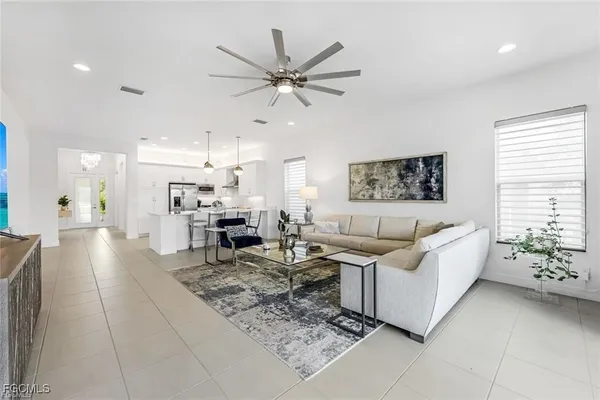 a living room with furniture and kitchen view