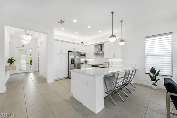 a view of kitchen with refrigerator and window
