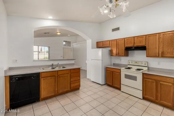 a kitchen with stainless steel appliances a sink and cabinets