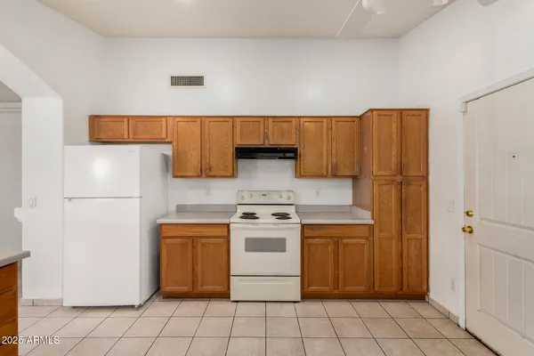 a kitchen with a stove top oven cabinets and appliances