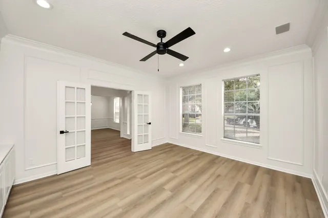 a living room with hard wood floors and white walls