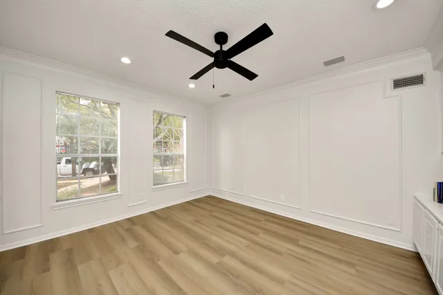 wooden floor in an empty room with a window