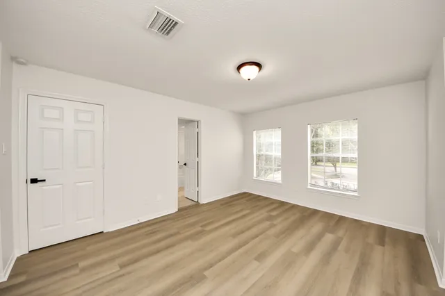 a bedroom with a bed and cabinets