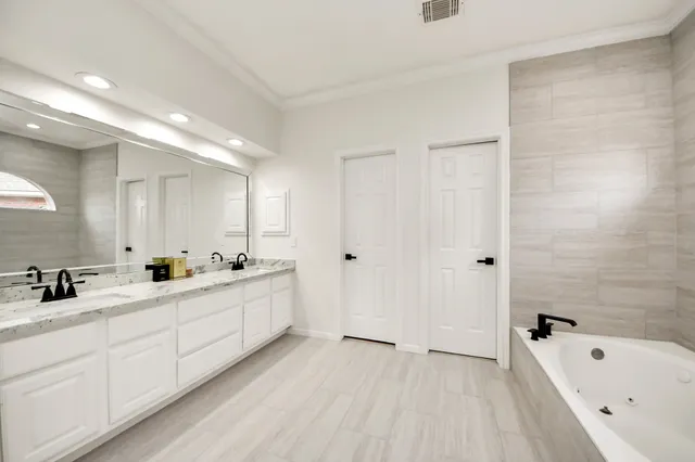 a bathroom with a tub and a shower