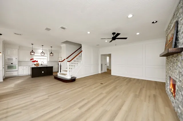 a view of an empty room with stairs and ventilation