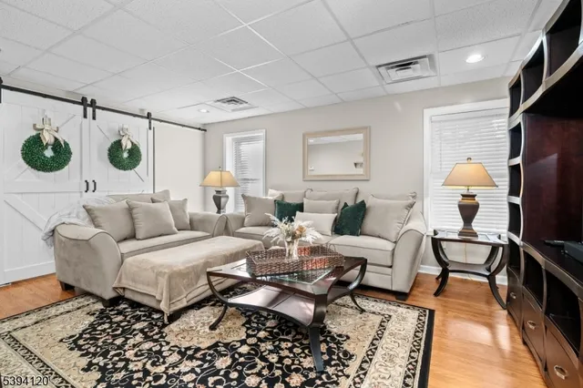 a living room with furniture and a table with wooden floor