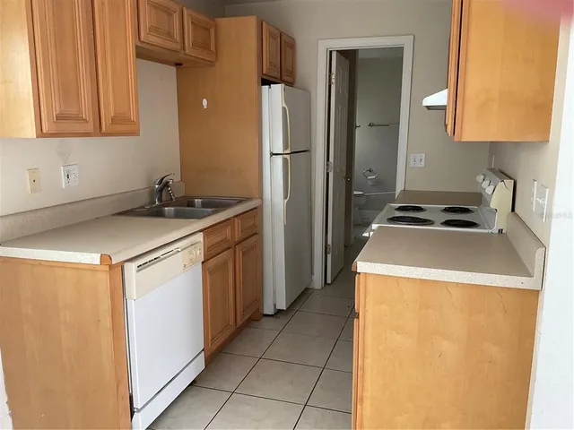 a utility room with sink washer and dryer