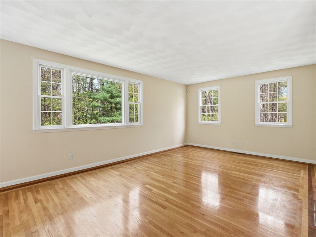 10 Hawk Ridge Road Andover, MA 01810 - Photo 13 of 32 a view of an empty room with wooden floor and a window