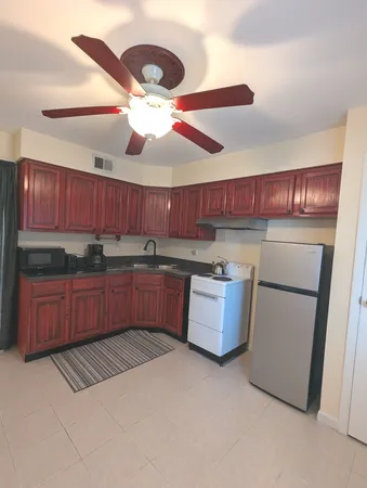 a kitchen with a refrigerator and a sink