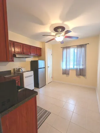 a kitchen with stainless steel appliances granite countertop a refrigerator and a stove top oven