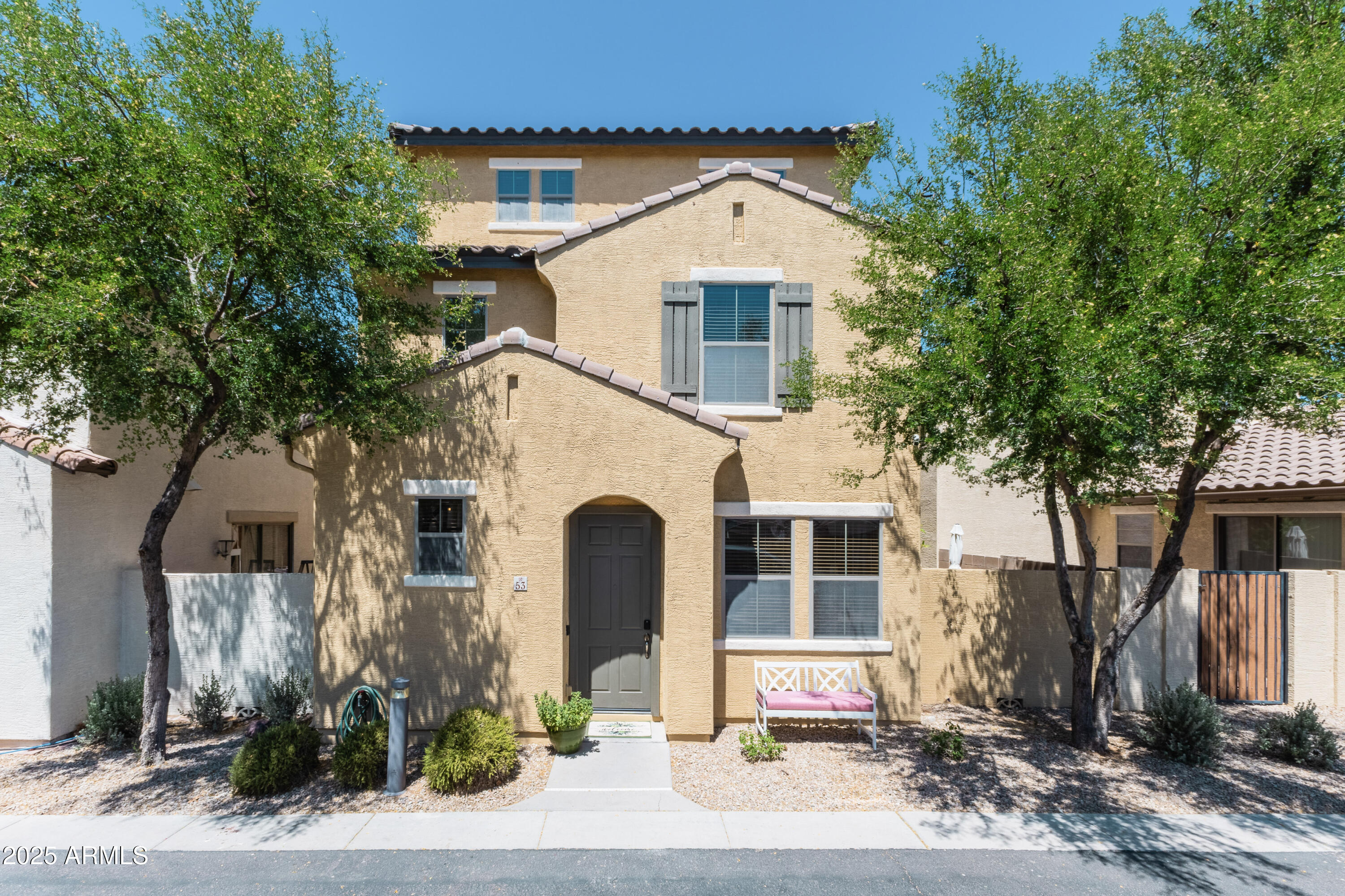 451 South Hawes Road, Unit 53 Mesa, AZ 85208 - Photo 1 of 37 a front view of a house with a yard and garage