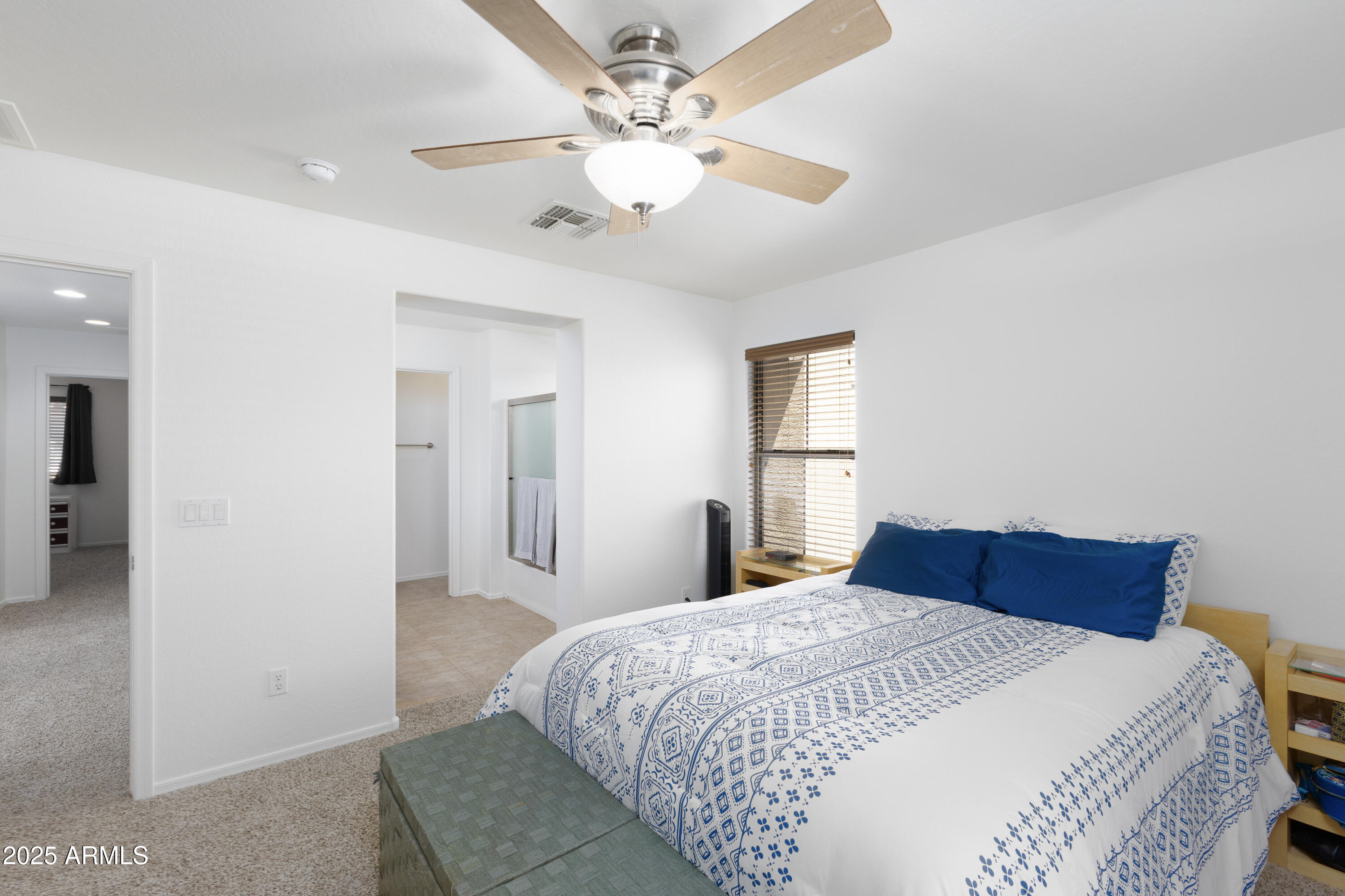 451 South Hawes Road, Unit 53 Mesa, AZ 85208 - Photo 16 of 37 a bedroom with a large bed and a chandelier