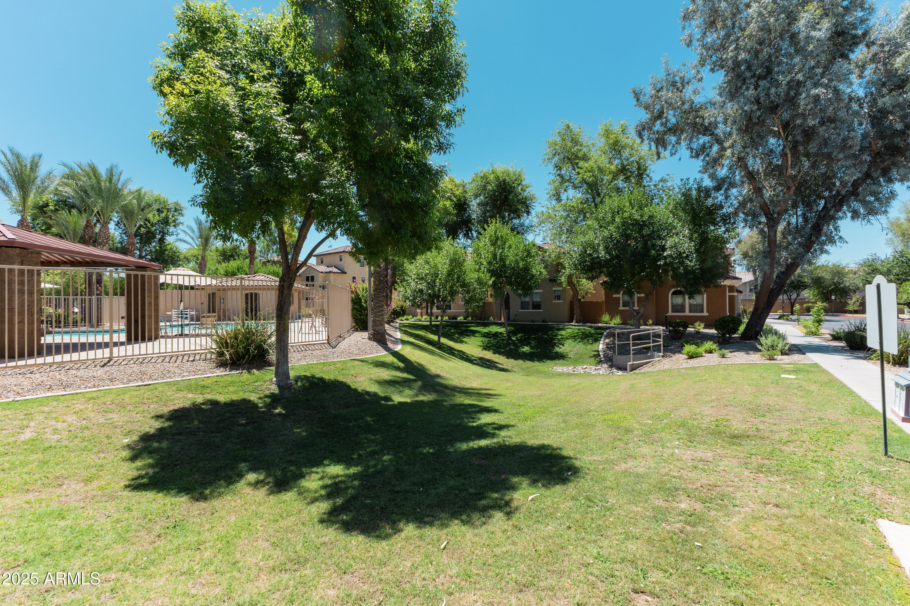 451 South Hawes Road, Unit 53 Mesa, AZ 85208 - Photo 34 of 37 a view of a backyard with table and chairs and a slide