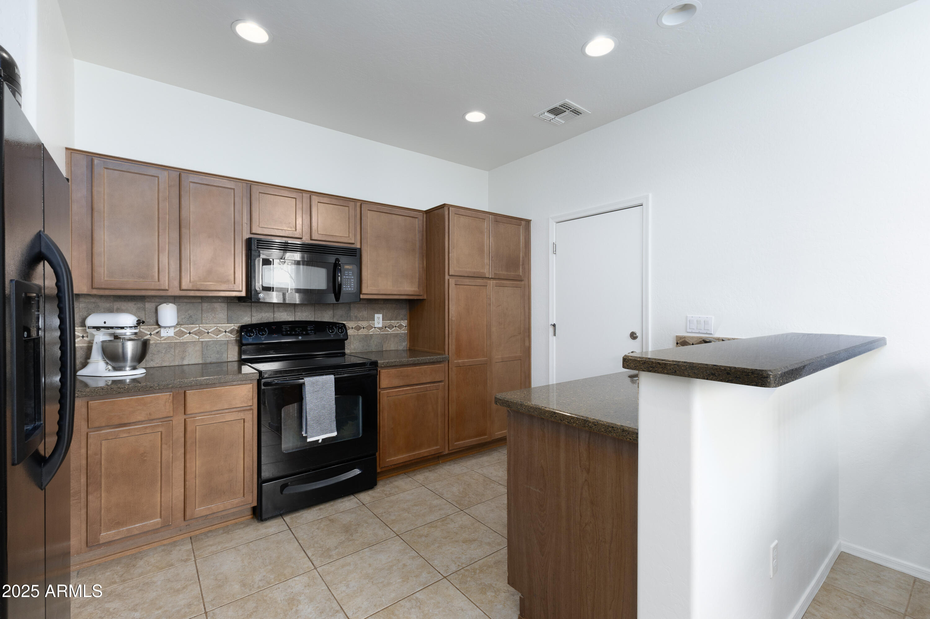 451 South Hawes Road, Unit 53 Mesa, AZ 85208 - Photo 9 of 37 a kitchen with stainless steel appliances granite countertop a refrigerator a stove a sink and a microwave