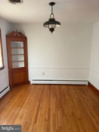 a view of a room with wooden floor and cabinet