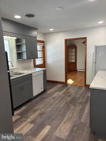 a view of a kitchen cabinets and wooden floor
