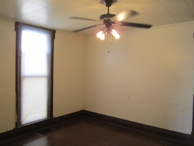 112 North Walnut Street Springfield, TN 37172 - Photo 4 of 11 an empty room with a chandelier fan and wooden floor