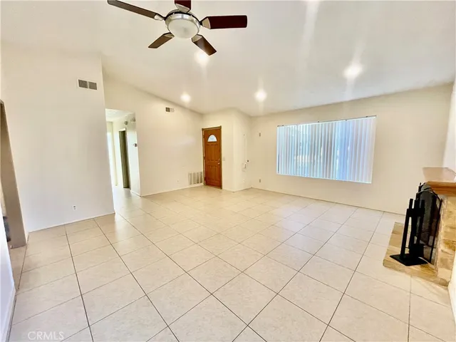 a view of a livingroom with furniture and a ceiling fan