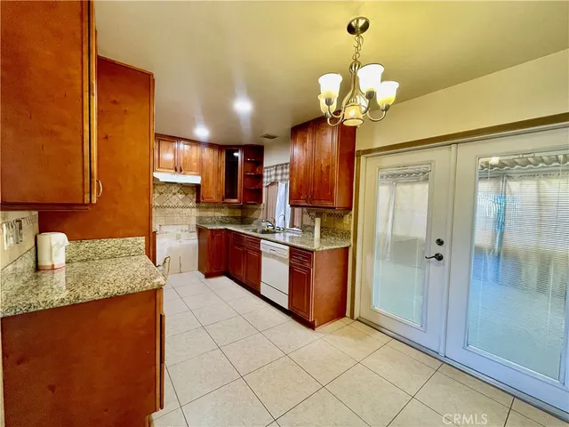 a kitchen with stainless steel appliances granite countertop a sink a counter space and cabinets