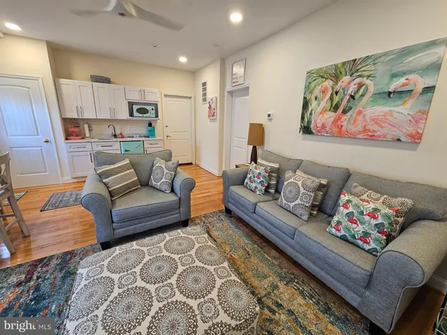 a living room with furniture and painting on the wall